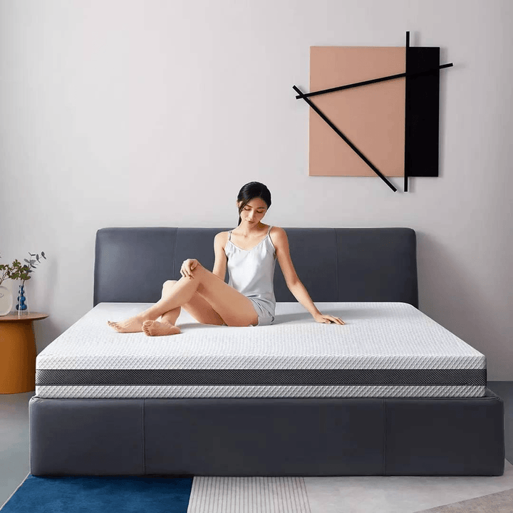 Girl sitting on a bed with a schcott natural latex mattress.