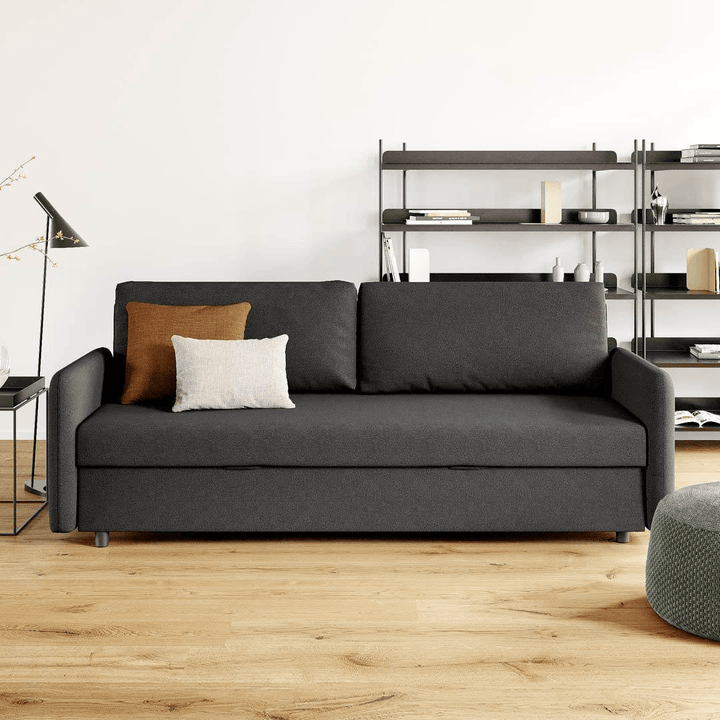 A folding grey sofa bed in the living room