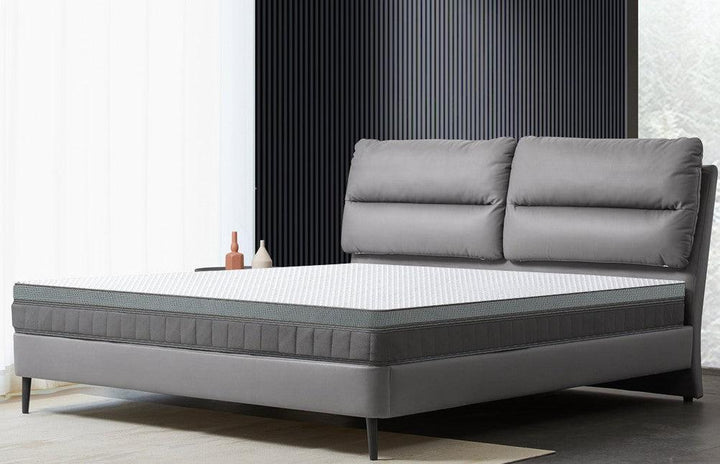 A grey leather bed with a schcott natural latex mattress.