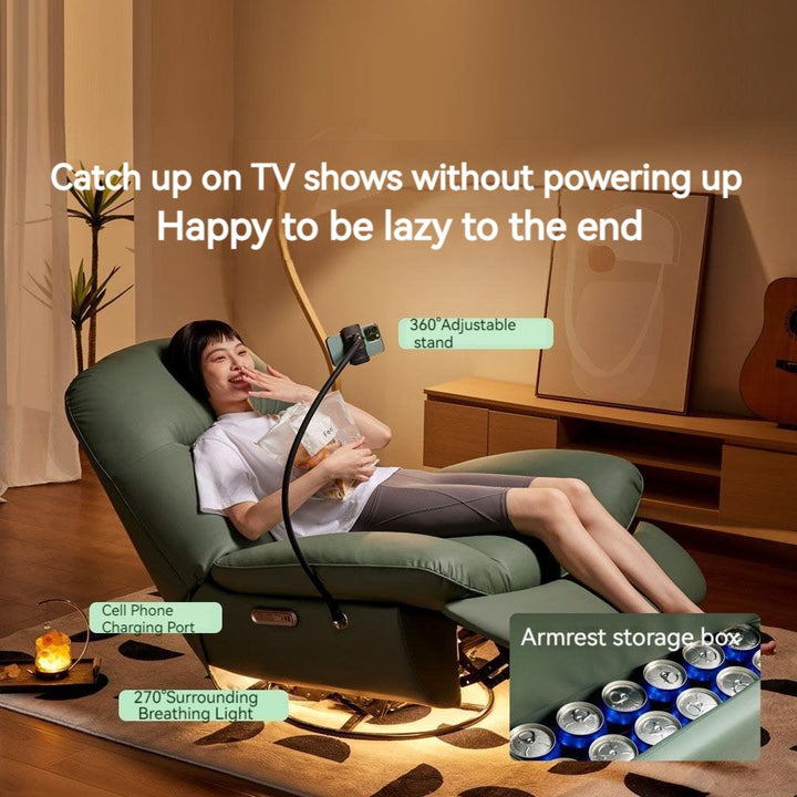 A girl sitting on a green smart electric lazy sofa eating a snack and watching a show