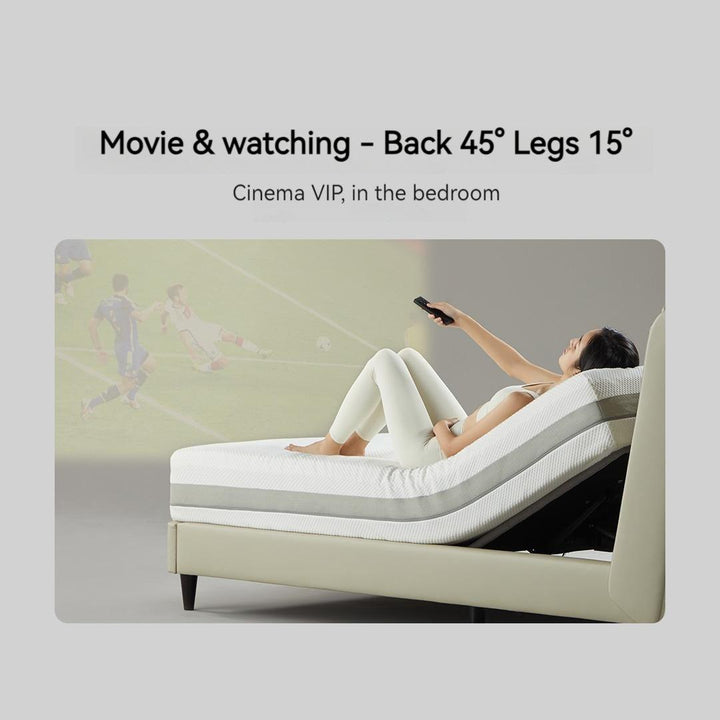 Girls lie on the Feel eco-leather smart electric bed F series with the back 45° and the legs 15° watching a movie.