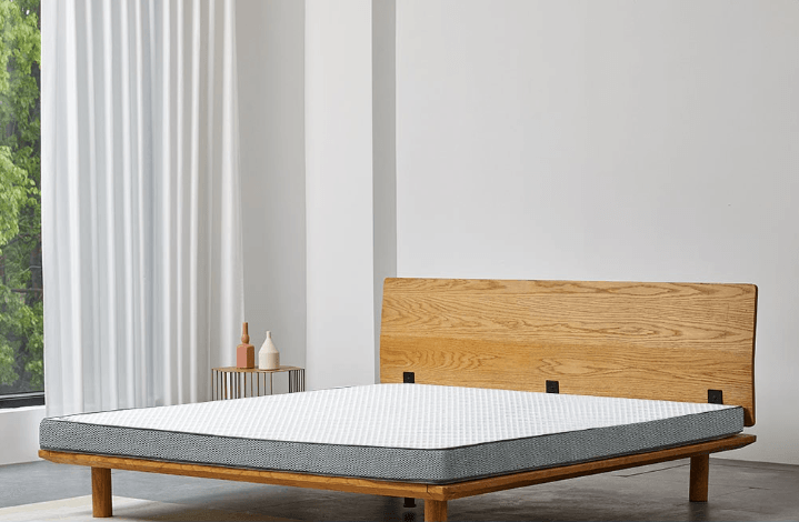 A wooden bed with a schcott natural latex mattress.